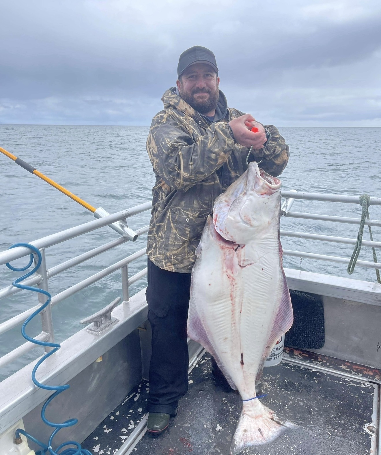 Dave Horne on a fishing boat holding his catch